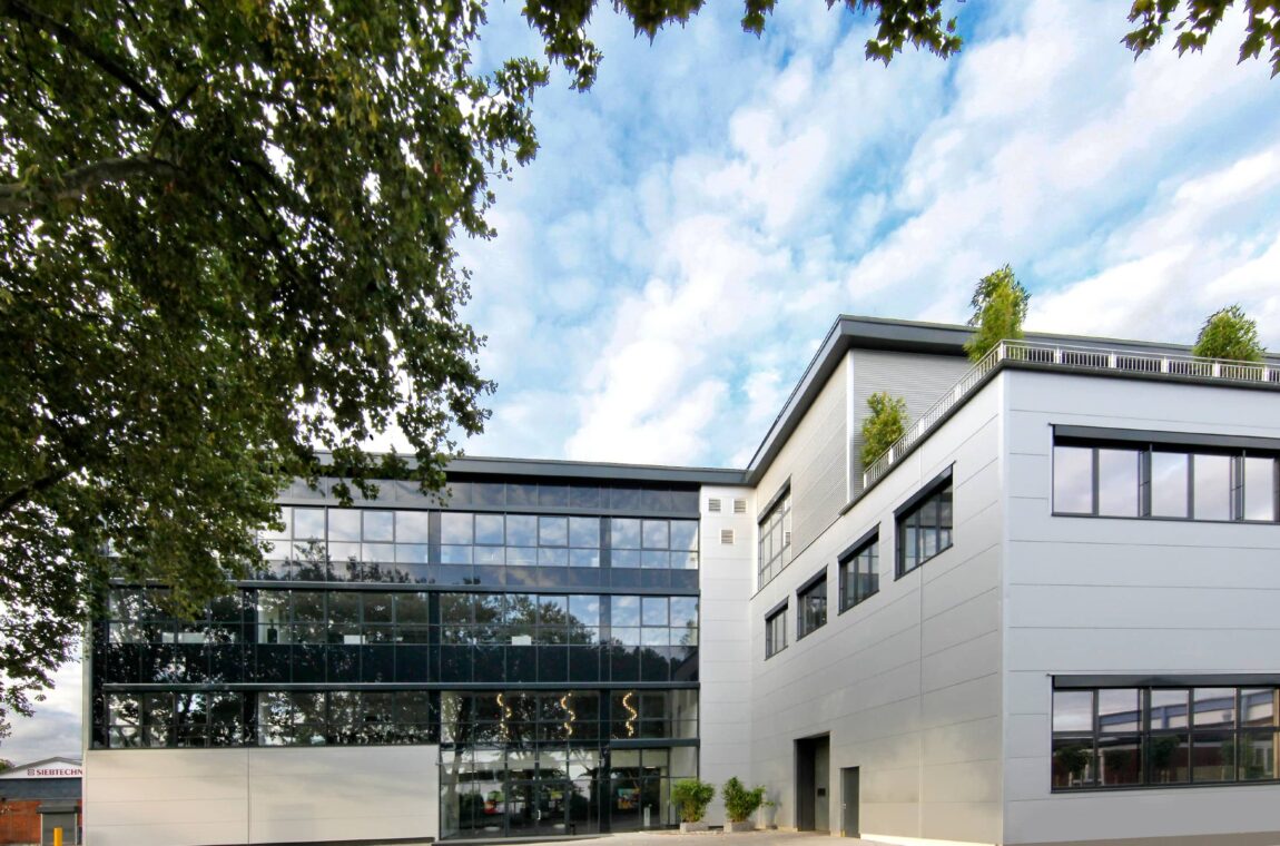 Exterior view of Weseler Strasse offices (factory premises) - you can see the glazed entrance, the conference floor with roof terrace is at the top right